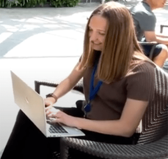 Meghan Baudendistel sitting outside with laptop